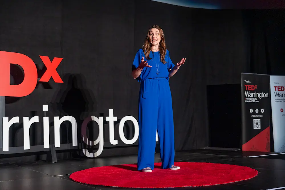 Dr Jess Morgan speaking on stage at TEDx Warrington